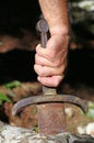 Hand of a Knight and the Excalibur sword in the stone Royalty Free Stock Photo