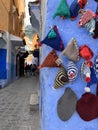 Hand knitted bobble hats on wall, Chefchaouen, blue city of Morocco Royalty Free Stock Photo