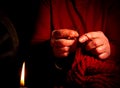 Hand knitting with woolen thread by candlelight Royalty Free Stock Photo