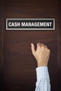 Hand is knocking on Cash Management door