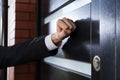 Hand knocking on the door Royalty Free Stock Photo