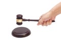 Hand knocking a Judge gavel at soundboard Royalty Free Stock Photo