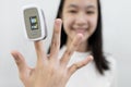 Hand of lady girl with an attached pulse oximeter on finger or fingertip  for examination of the lung disease,diagnose of Royalty Free Stock Photo