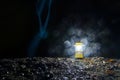 Hand lantern on rocks on background of waterfall