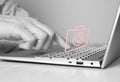 Hand at laptop keyboard and virtual first aid kit. Man searching information about urgent medical care or list of Royalty Free Stock Photo