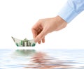 Hand launching money ship Royalty Free Stock Photo