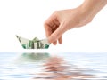 Hand launching money ship Royalty Free Stock Photo