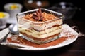 hand layered tiramisu in a transparent glass dessert dish