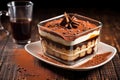 hand layered tiramisu in a transparent glass dessert dish