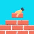 Hand laying brick on wall flat vector illustration. Hand holding brick.