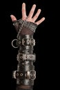 Hand in Leather Cuffs on Black Royalty Free Stock Photo