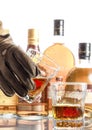 Clang glasses together. Man`s hand with a glass and a glass with an alcoholic drink on the table