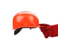 Hand in leather gloves holds hard hat. Royalty Free Stock Photo