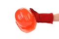 Hand in leather gloves holds hard hat. Royalty Free Stock Photo