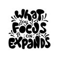 Hand Lettered What You Focus On Expands On White Background Royalty Free Stock Photo