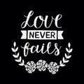 Hand lettering with bible verse Love never fails made with flowers on black background Royalty Free Stock Photo