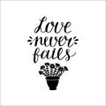 Hand lettering with bible verse Love never fails made with flowers in pot. Royalty Free Stock Photo