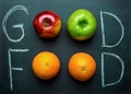 Hand Lettering Good Food on Black Chalkboard with Fruits Oranges Green Red Apples. Healthy Clean Eating Vegan. Vitamins Energy. Royalty Free Stock Photo