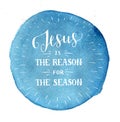 Hand lettering Jesus is the reason for season on blue watercolor background.