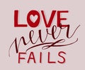 Hand lettering with bible verse Love never fails . Royalty Free Stock Photo