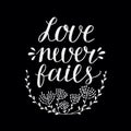 Hand lettering Love never fails made with flowers and leaves on black background Royalty Free Stock Photo