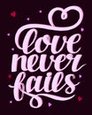 Hand lettering with bible verse Love never fails . Royalty Free Stock Photo