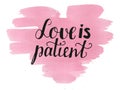 Hand lettering Love is patient made on watercolor background with heart.