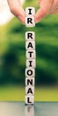 Hand lifts two dice and changes the word `irrational` to `rational.