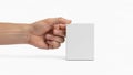 Skin tone is holding a small, plain white rectangular box against a Royalty Free Stock Photo