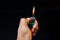 Hand with lighter igniting