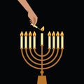 Hand Lighting Candle On Metal Hanukkah Menorah On Surface Against Black Background. Man lighting up candles in menorah. Jewish Royalty Free Stock Photo