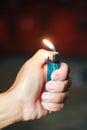 hand is lighting a match with blurbackground