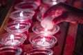 Hand Lighting up prayer candles inside a church in Vienna, Austria Royalty Free Stock Photo