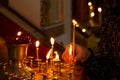 Hand with a lit candle in the church-a woman puts a candle to her saint Royalty Free Stock Photo