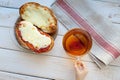 The hand of a little boy who is holding a mug of tea. Royalty Free Stock Photo