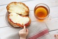 The hand of a little boy who is trying to steal my father`s sandwich with tea. Royalty Free Stock Photo