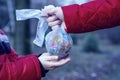 Hand of a little child reaching out to take a globe in plastic bag from an adult so he can take care of the earth for his future. Royalty Free Stock Photo