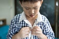 Hand of little child is trying to wear shirt,asian student buttoning his shirt at home,kid boy kindergarten self learning to Royalty Free Stock Photo