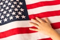 Hand of a little girl on the background of the American flag. The concept of patriotism Royalty Free Stock Photo