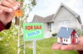 Hand with a little house and keys. Royalty Free Stock Photo