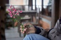 Hand with little pink roses plant. Still life concept