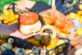 Hand with little pumpkin on blurred background Royalty Free Stock Photo