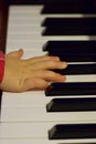 The hand of a little year-old child who plays the piano