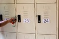 A hand with a locker key Numbered lockers For safety Royalty Free Stock Photo