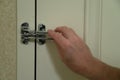 Hand locking lock on hotel door Royalty Free Stock Photo