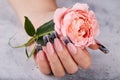 Hand with long artificial manicured nails colored with black nail polish Royalty Free Stock Photo