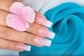 Hand with long artificial manicured nails with ombre gradient design