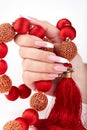 Hand with long artificial white and black french manicured nails and red necklace Royalty Free Stock Photo