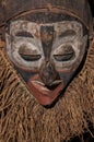 Hand made African mask with ropes simulating hair. Royalty Free Stock Photo