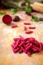 Hand made beetroot pasta on a wooden table